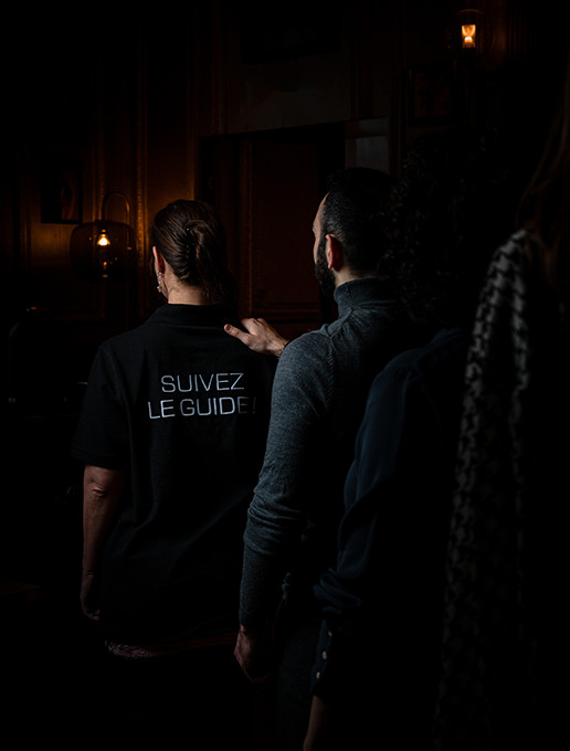 Invités en file indienne se rendant à un anniversaire immersif au restaurant Dans le Noir ?